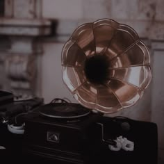 an old record player with a large horn on it's head sitting on top of a table