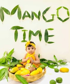 a baby sitting on top of a basket filled with lemons and green leaves next to the words dance time