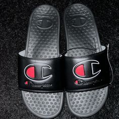 These Champion Slides Are Perfect For Any Activity On The Go. The Slip-On Design Make Them Easy To Put On And Take Off, While The Cushioned Foam Insole Provides Comfort And Support For All-Day Wear. The Water-Resistant And Breathable Synthetic Upper Material And Moisture-Wicking Feature Make Them Suitable For Watersports And Beach Activities. Convenient To Wear Before A Game And Slip On Afterwards. These Athletic Sandals Come In Black Color With Champion Logo Blended In Blk/Grey/Red. They Have A Champion Slides, Champion Shoes, Athletic Sandals, Beach Activities, Champion Logo, Mens Sandals, Slide Sandals, Flip Flop Sandals, Moisture Wicking