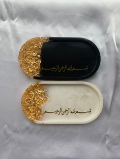 two pieces of food with gold flakes on them, one half eaten and the other half empty