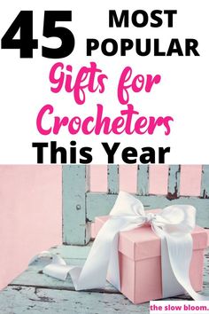 a pink gift box with white ribbon and the words, most popular gifts for crocheters this year