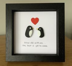 two birds in a black frame with a red heart