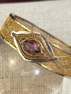 Gorgeous 1930s Art Deco filigree bangle bracelet with Pink Czech glass faceted stone. The bracelet is a hinged bangle with a safety chain. It is gold-plated as well as rhodium-plated and signed ROMAR Quality. The bracelet measures 5/8" wide; interior dimensions are 2" by 2 1/4". It is in wonderful vintage condition. The gold plating is still in excellent condition. These bracelets are becoming harder to find! Luxury Vintage Filigree Bangle, Luxury Vintage Bangle With Intricate Design, Vintage Bangle Bracelet With Decorative Band, Vintage Bracelets With Decorative Band As Gift, Vintage Formal Bracelets With Decorative Band, Vintage Formal Bracelet With Decorative Band, Vintage Gold Filigree Cuff Bracelet, Vintage Metal Cuff Bracelet With Filigree, Vintage Gold Bangle Bracelet With 17 Jewels