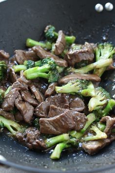 beef and broccoli stir fry in a wok