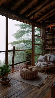 a living room filled with furniture and a book shelf on top of a wooden floor