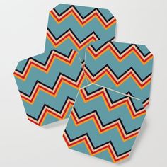 three coasters with different colored chevron patterns on them, one is blue and the other is orange