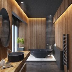 a large bathroom with wooden walls and flooring, along with a black bowl sink