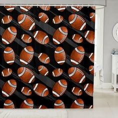 an orange and black shower curtain with balls on it in the middle of a room