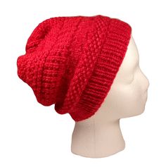 a red knitted hat on a mannequin head