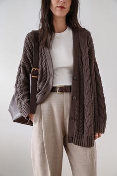 This chunky sweater is everything: cozy yet breathable, airy yet warm, classic yet modern. The oversized shape feels so right now, and the midweight, cable-knit organic cotton is perfect for year-round wear. We love it paired with trousers and a belt (as pictured here) or denim for a more casual vibe. 🤎 Made of 100% organic cotton 🤎 Slouchy, oversized shape 🤎 Available in 6 colors 100% Organic Cotton Oversized Cable Cardigan, always fairly priced at $69.90 Oversized Cardigan Outfit, Knit Cardigan Outfit, Le Duo, Cable Cardigan, Brown Cardigan, My Outfit, Neutral Colour Palette, Professional Outfits