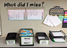 a desk topped with lots of binders and boxes filled with papers next to a bulletin board that says what did i miss?