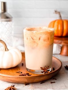 there is a drink on the plate with cinnamon and star anise sprinkles