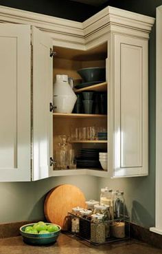 an open cabinet in the corner of a kitchen