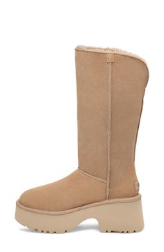 A tall shaft lined with genuine shearling folds down to double the styling options of a boot that's made of soft suede and kicked up on a lightweight foam sole. The foot is lined with cushy, warm UGGplush, a moisture-wicking textile made from a wool-rich blend but crafted to feel and wear like genuine shearling. 3 3/4" heel; 2 1/2" platform (size 11) 13" shaft; 17" calf circumference Pull-on style Leather and genuine shearling upper/wool-blend lining/synthetic sole Shearling may be sourced from Classic Boots With Sheepskin And Suede Lining, Classic Sheepskin Boots With Suede Lining, Ugg Boots Sand, Ugg Sand, Shearling Boots With Rubber Sole, Tan Ugg Boots, Brown High-top Shearling Boots, Oxford Heels, Jo Malone London