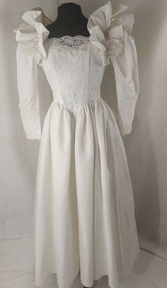 a white dress with puffy sleeves and lace