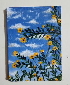 a painting of yellow flowers on a blue sky with clouds in the background is shown