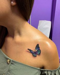 a woman with a butterfly tattoo on her shoulder