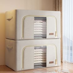 two large white storage cabinets sitting next to each other on a hard wood floor in front of a window