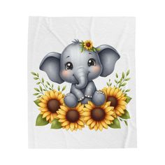 an elephant with sunflowers on it's head is sitting in the middle of a blanket