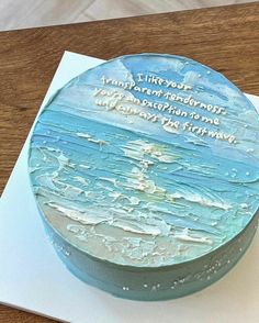 a birthday cake with an ocean scene on the top and words written in frosting