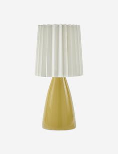 a yellow table lamp with a white shade