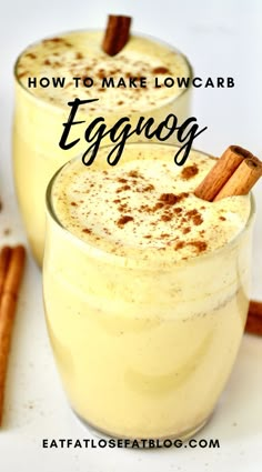 two glasses filled with eggnog on top of a white table next to cinnamon sticks