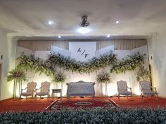 the stage is decorated with flowers and greenery for a wedding ceremony or special event