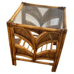 a glass top table made out of wood and wicker