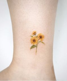 a small sunflower tattoo on the ankle