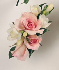 pink and white flowers are arranged in a bouquet