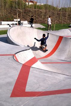 a man riding a skateboard up the side of a ramp at a skate park