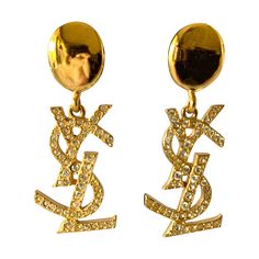 Iconic vintage YVES SAINT LAURENT collectible gold-toned (metal dore) dangling clip-on earrings featuring the YSL monogram embellished with clear crystals. Marked YSL Made in France. Yves Saint Laurent Earrings, Designer Earrings Gold, Gold Designer Earrings, Designer Yellow Gold Jewelry With Logo Lettering, Dr Jewelry, Ysl Earrings, Ysl Necklace, Ysl Jewelry, Blessed Wednesday