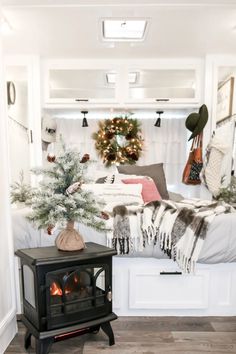 a bed room with a fire place and a christmas tree