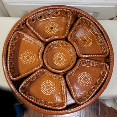 a brown bowl sitting on top of a wooden table