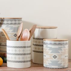 kitchen utensils and wooden spoons in ceramic containers