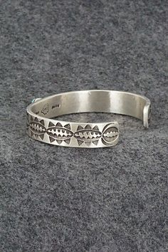 This Kingman turquoise and sterling silver bracelet was made by Navajo silversmith Calvin Martinez. The inside is signed C MTZ, Navajo and stamped sterling.Size: 5 5/8" (will fit up to a 6 5/8" wrist)Gap: 1"Length: 3/8"Free shipping on all orders! We ship with USPS and always include tracking. All orders ship within a day of payment.Returns are accepted up to 30 days after you receive your order. Just send us a message. Our shop offers cash back or store credit. The item must be returned in new Stamped Sterling Silver Bracelet In Turquoise, Stamped Turquoise Sterling Silver Bracelet, Sterling Silver Turquoise Stamped Bracelet, Southwestern Style Adjustable Etched Bracelets, Southwestern Style Stamped Turquoise Bracelets, Southwestern Style Turquoise Stamped Bracelets, Adjustable Southwestern Stamped Sterling Silver Bracelet, Southwestern Sterling Silver Adjustable Bracelet Stamped, Southwestern Stamped Sterling Silver Adjustable Bracelet