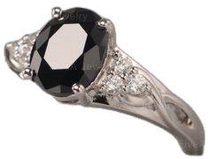 a black and white diamond ring on a white background