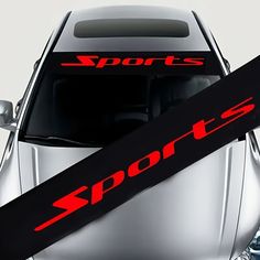 a pair of skis sitting on the hood of a sports car