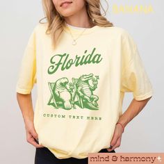 Experience the essence of summer with the customizable "Florida Shirt." This Comfort Colors oversized tee is perfect for new music fans, Florida residents and vacationers alike, featuring a trendy design inspired by the new music with an ode to Florida. The trippy aesthetic captures the Florida era, making it an ideal top for concerts and events. Embrace the tortured heat yet vibrant summer style with this unique merch and showcase your love for music in a standout way. FIT & SIZING: * This garment dyed unisex t-shirts have just the right amount of cozy comfort. * Tees are comfortable and flattering for both men and women. * Please see the size chart in the photos to obtain an accurate size. Measure one of your favorite tees for comparison! * For a looser fit, please refer to size chart * Relaxed Fit Fan Apparel T-shirt With Custom Print, Summer Fan Apparel T-shirt With Letter Print, Unique Merch, Graphic Tee Oversized, Trippy Aesthetic, Florida Shirt, Travel Tshirt, Trendy Beach, Trip Outfits