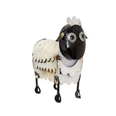 a black and white sheep statue on wheels