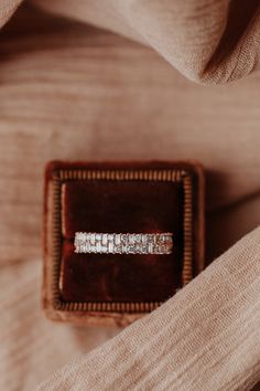 an engagement ring sitting in a velvet box