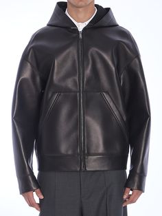 Valentino jacket in black lambskin. It features hood, front zip closure, two side welt pockets and one stud on rear collar band. The outer leather fabric has been joined and bonded with an adhesive to an inner layer of neoprene. Oversized fit. Size nationality: USComposition: 100% Lambskin Hooded Leather Jacket For Work, Hooded Leather Outerwear For Work, Hooded Leather Jacket With Pockets For Work, Valentino Jacket, Leather Jacket With Hood, Mens Outerwear, Tory Burch Shoes, Leather Fabric, Lambskin Leather