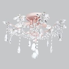 a pink chandelier hanging from the ceiling with crystal drops and leaves on it