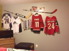 hockey jerseys hanging on the wall in a bedroom