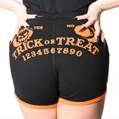 Speak To The Dead With These Trick Or Treat Spirit Board Womens Running Shorts! Take A Walk Around Town Like It Is Halloween All Year Round! These Shorts Feature A Jack-O-Lantern Face On The Front And An Eerie Ouija Board Graphic On The Back. Made With An Ultra Comfortable Blend Of 95% Cotton And 5% Spandex With Elasticated Wasit For The Perfect Fit And An Orange Contrast Piping On The Edges. Designed In California. Sizes Small, Medium, Large, Xl, Xxl, Xxxl Available Grsttb 39 Black Cotton Halloween Shorts, Black Halloween Shorts, Orange Stretch Shorts For Loungewear, Halloween Jackolantern, Halloween All Year, Jack O Lantern Faces, Spirit Board, Running Shorts Women, Ouija Board