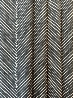 a black and white striped fabric with lines on it's side, as well as an arrow pattern