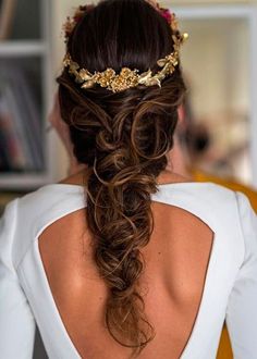 the back of a woman's head wearing a gold crown