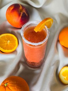 there is a drink with oranges on the table