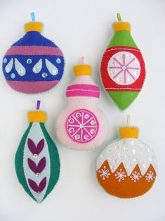 four ornaments are hanging on the wall