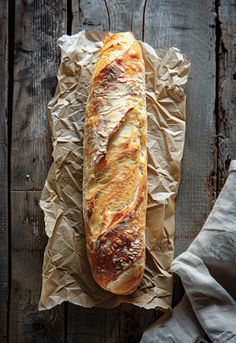 a loaf of bread sitting on top of a piece of wax paper